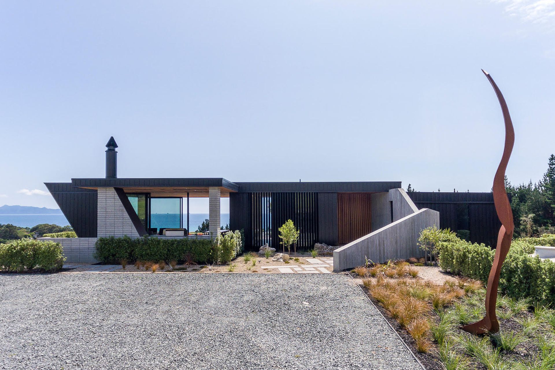Approaching the house, an in situ concrete spine wall is the first element the visitor interacts with, its prime purpose to protect the entry from the prevailing wind.