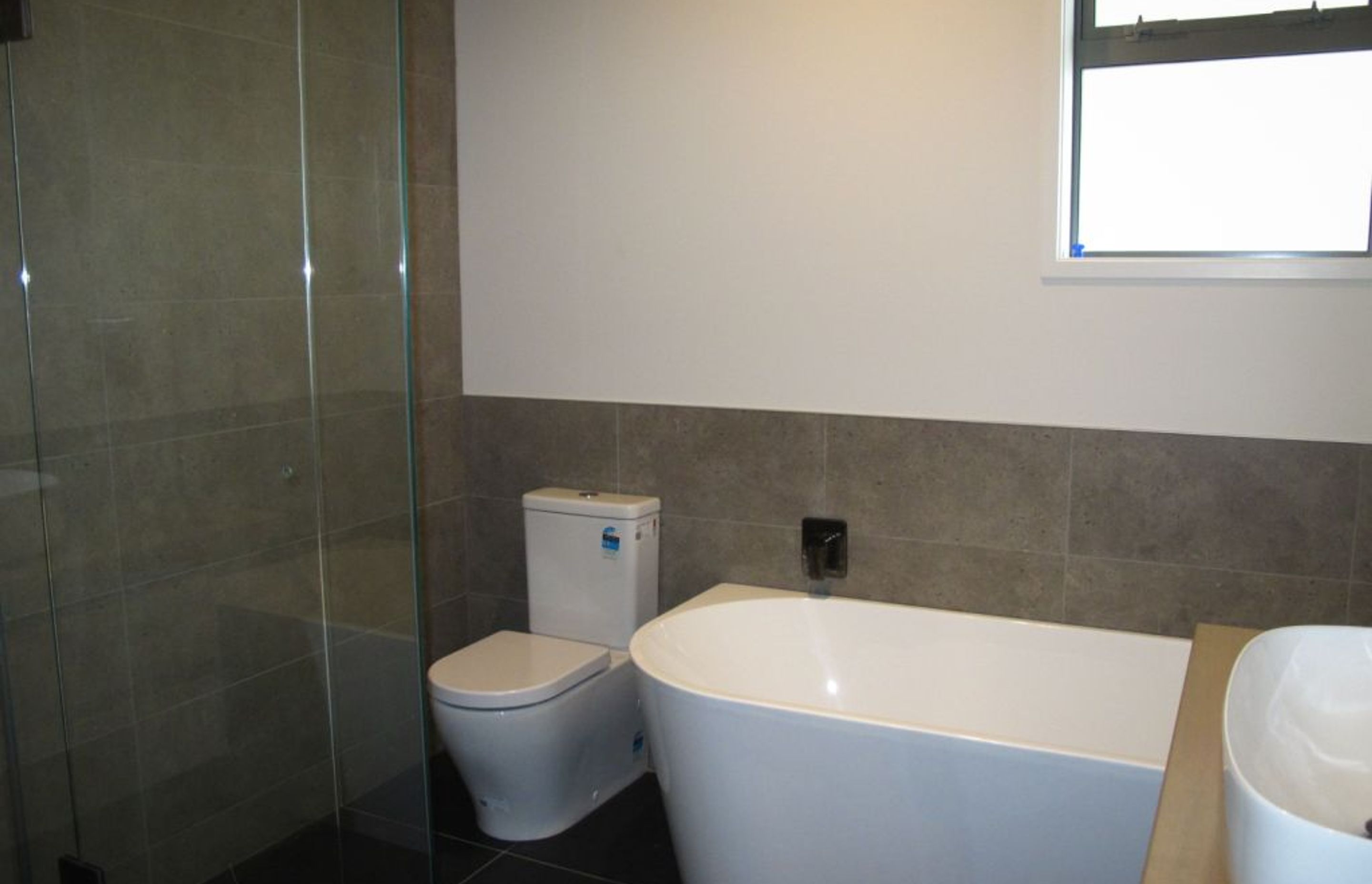 The main bathroom with tiled shower in a new residential build