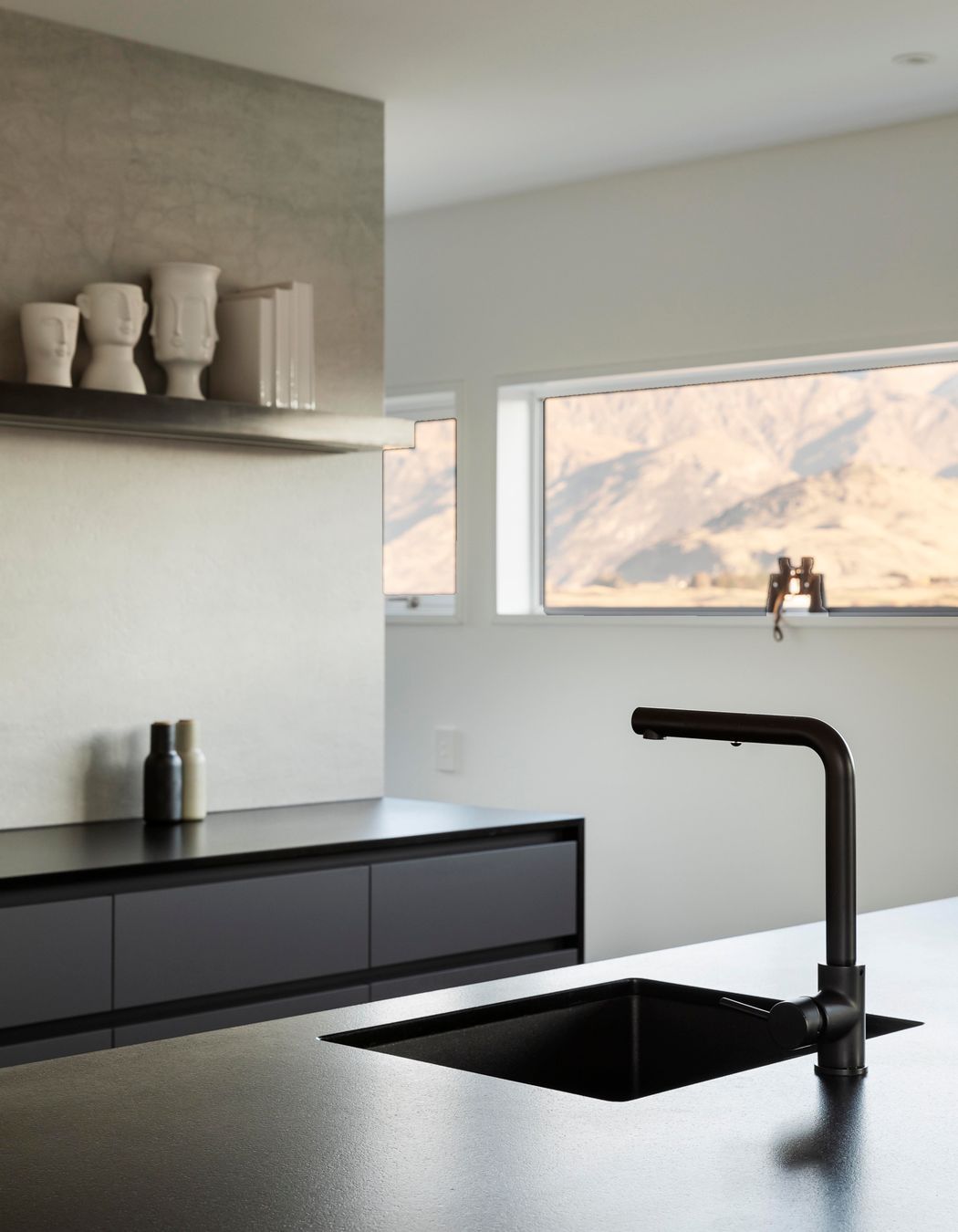 A slot window that runs along the kitchen wall at head height, captures The Remarkables perfectly.