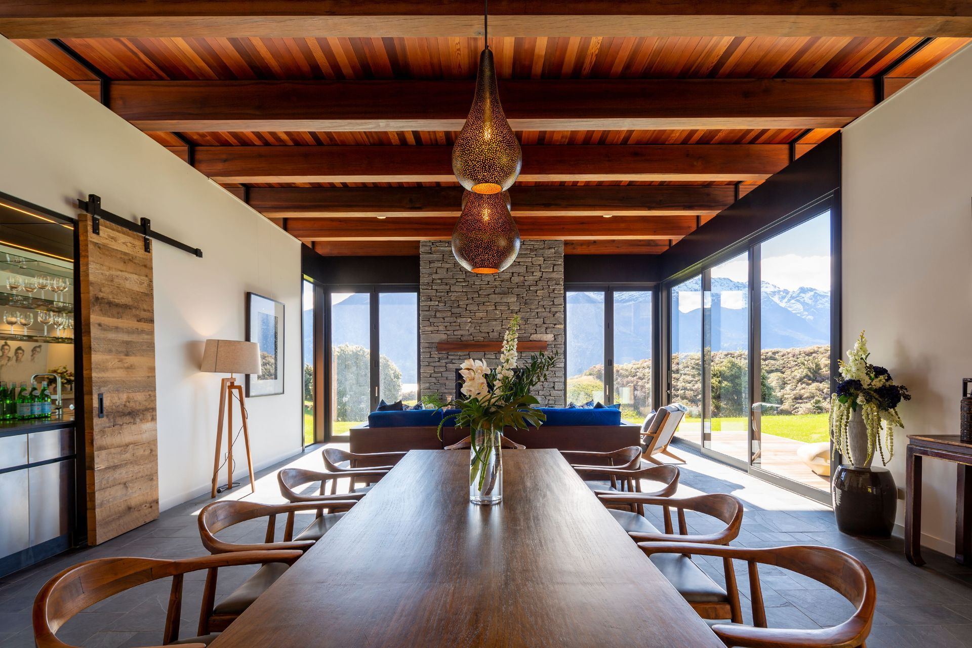The fireplace is clad in schist stone, following in from the exterior.