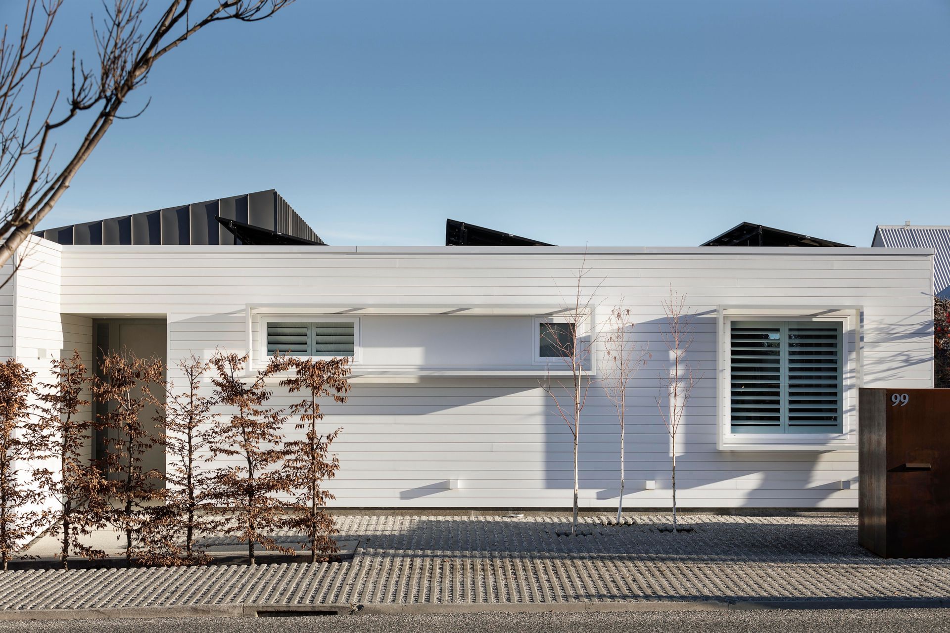 Above the white plinth-like front elevation you can see the solar panels carefully orientated to the sun.