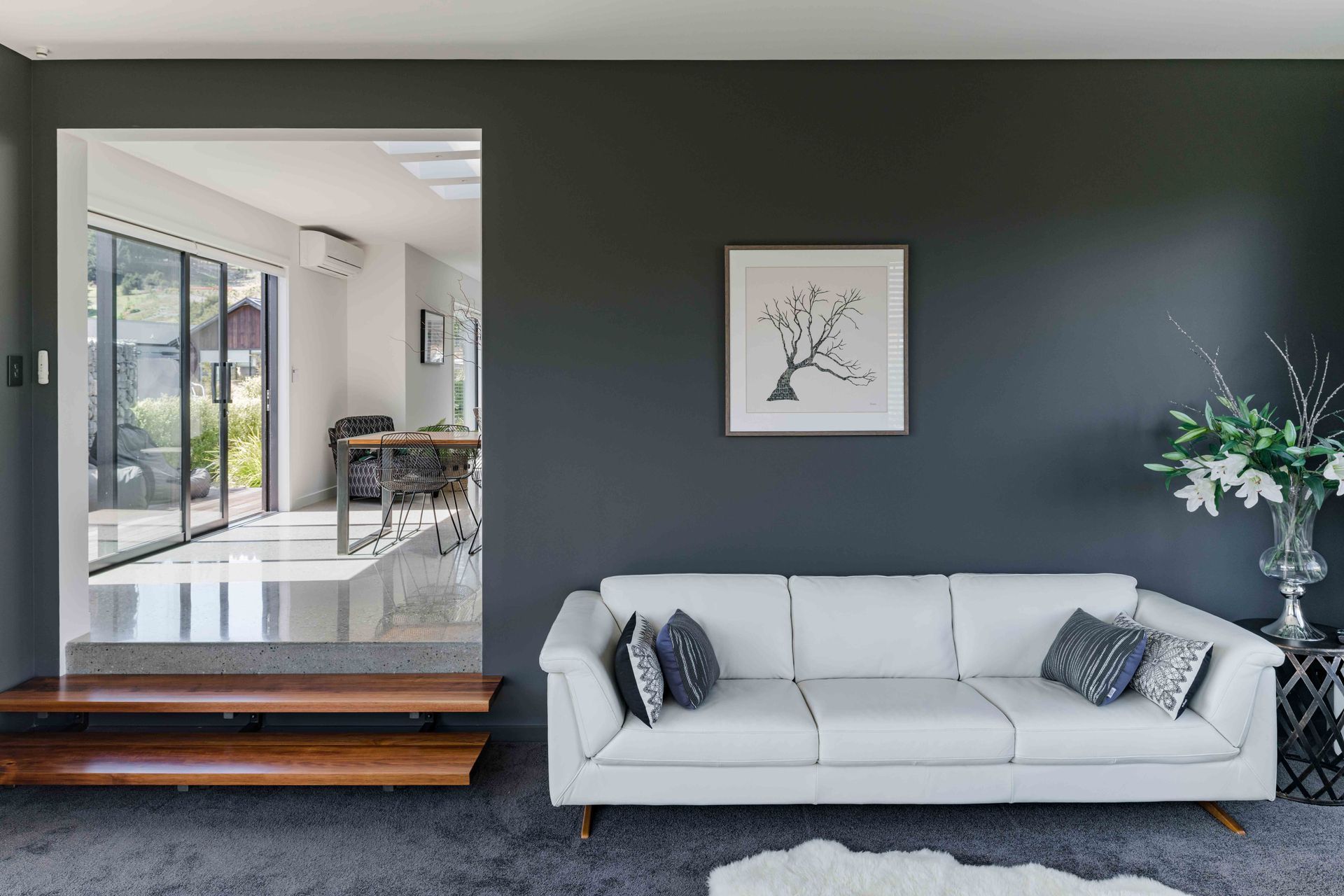 Dulux 'Castlecliff', a grey with a warm undertone, makes the living room more intimate whereas elsewhere the walls are painted Dulux 'Mt Aspiring'.