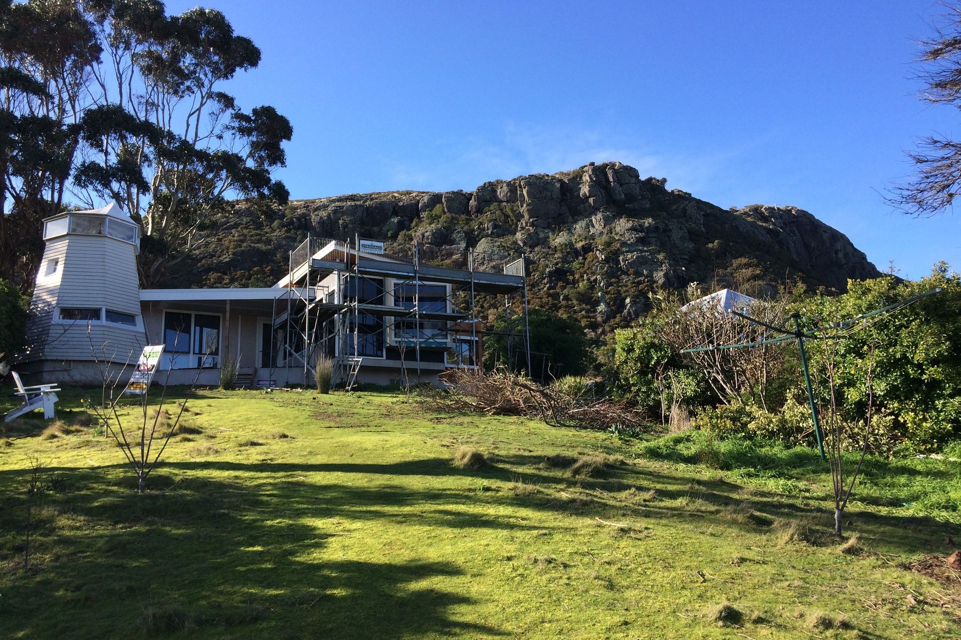 The cottage emerges from the site. It was important to maintain the visual dominance of the Windmill. New works do not interfere with the outline of The Nut from the village