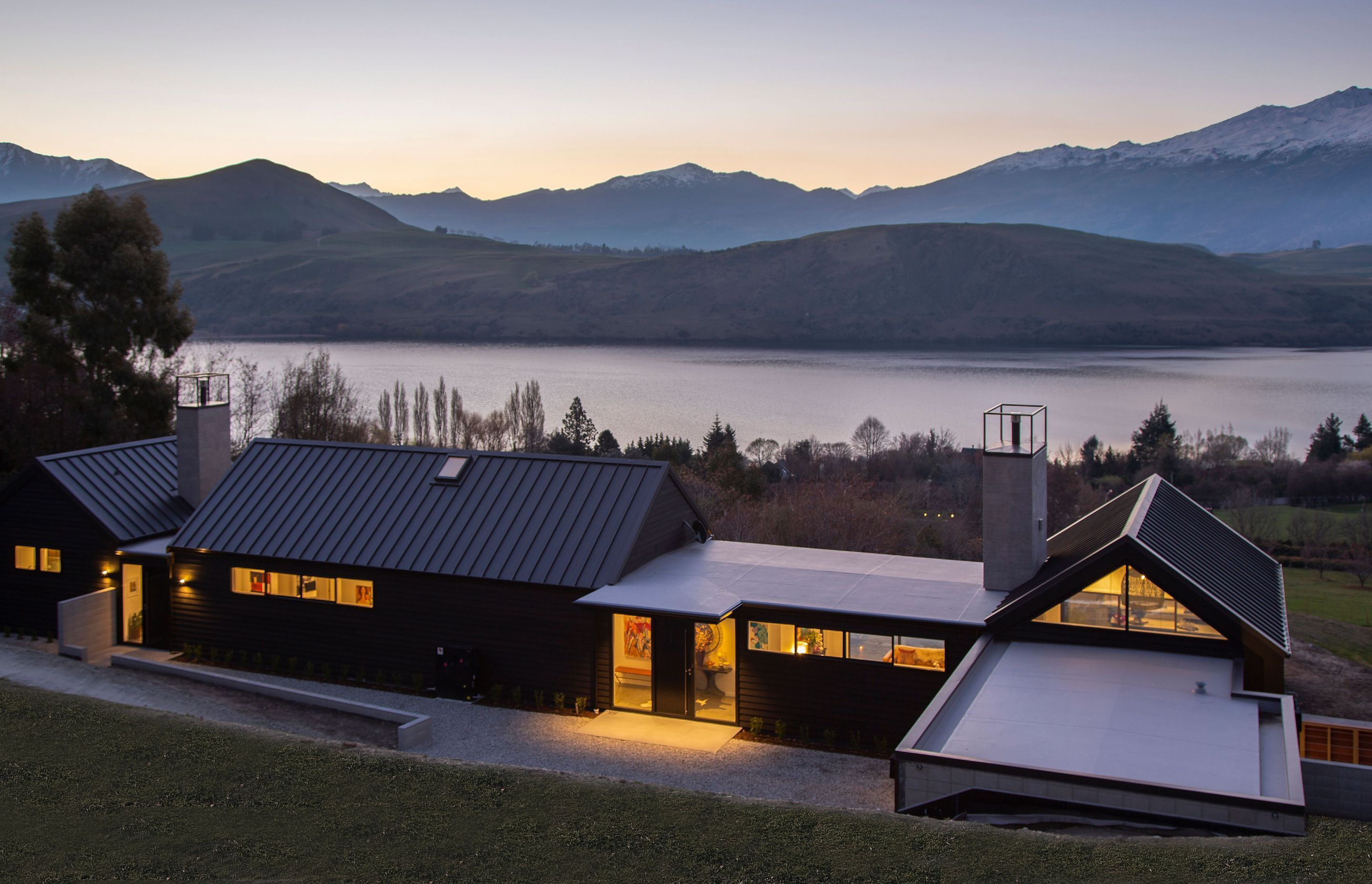 Steel tray roofing on the triangular forms providing a robust reflection of the mountainous terrain surrounding the home.