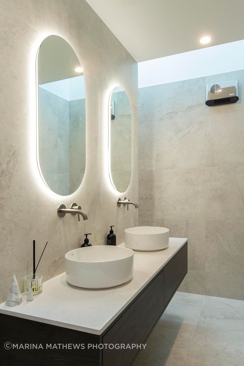 Modern-ensuite-with-twin-vanities-and-oval-mirrors.jpg