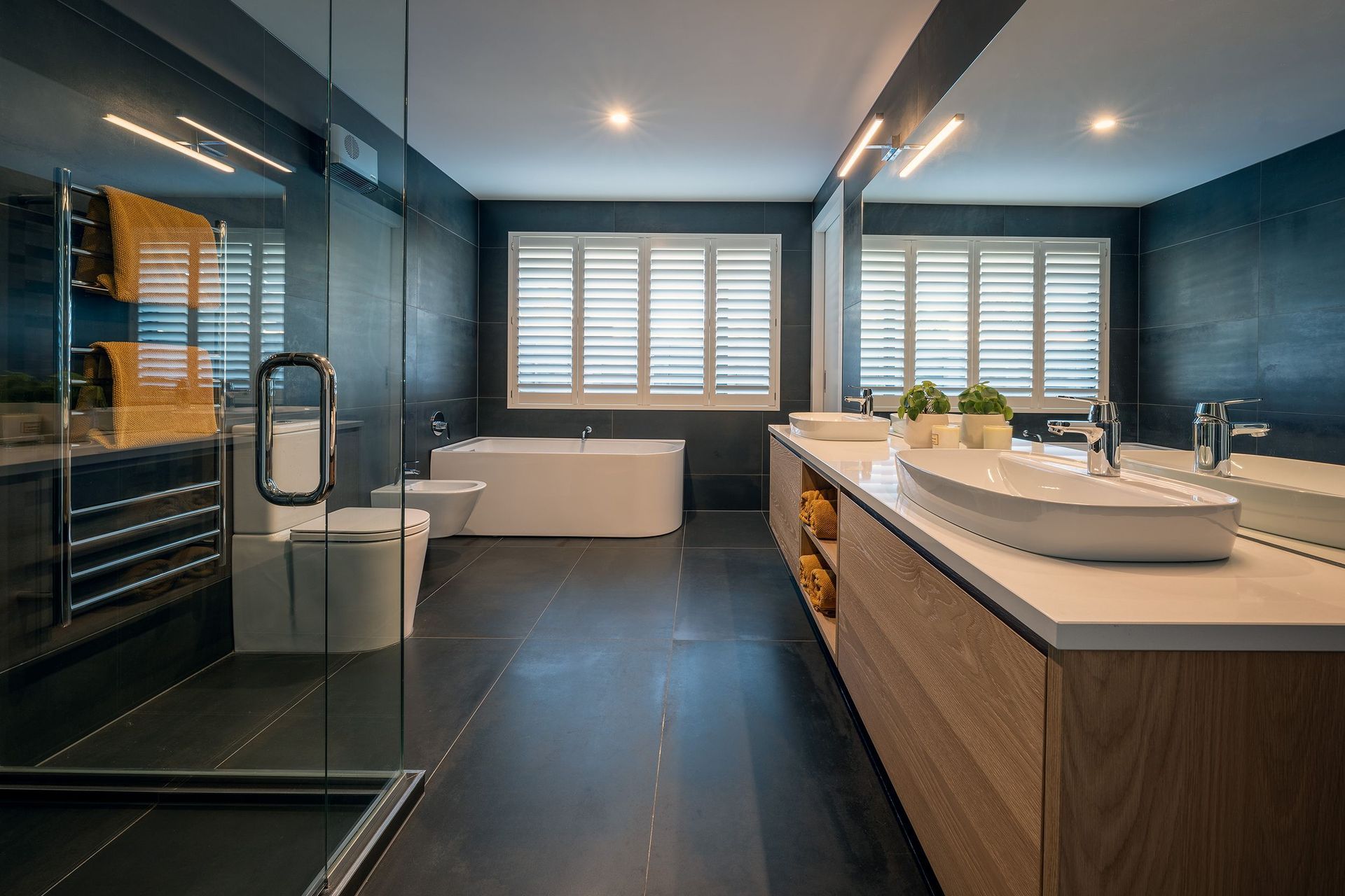 A pared-back colour palette gives the ensuite bathroom a dramatic, yet soft, aesthetic.