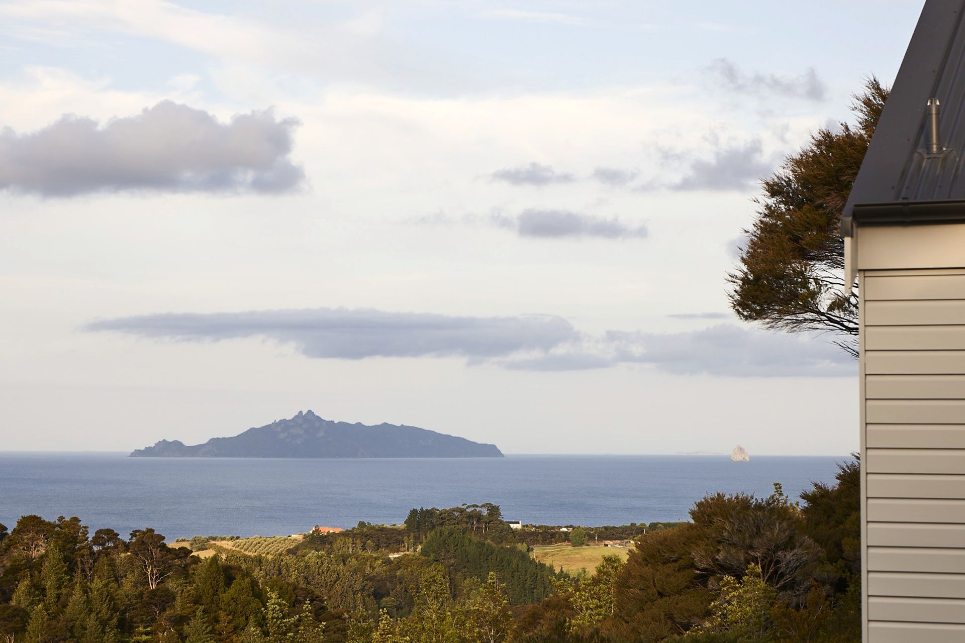 Expansive views across Waipu Cove connect the home to its remarkable coastal setting. The changing light, native bush and ocean outlook are integral to the experience of living in the house.