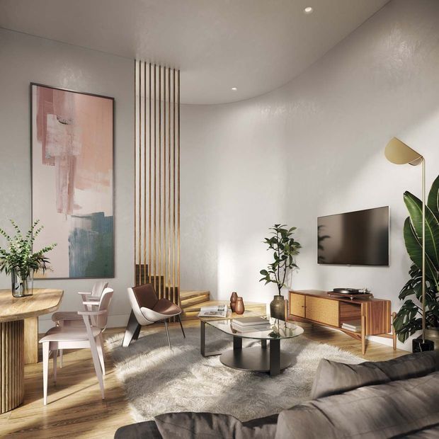 A warmly styled contemporary living room with a curved white plaster ceiling and walls, timber screen battens dividing the dining and lounge areas, a mid-century-inspired timber media console, layered round coffee tables, sculptural lounge chairs, indoor plants, abstract artwork, and a large textured rug. The room is softly lit with recessed ceiling lights and a brass-toned floor lamp.