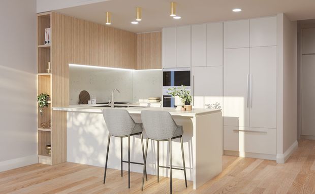 Bright contemporary kitchen with a compact island and two bar stools, white full-height cabinetry, pale timber flooring, vertical timber wall panelling, and a light stone-look splashback. Integrated appliances and warm pendant lighting create a clean, refined interior.