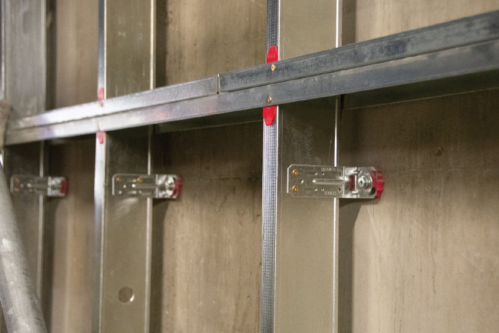 The M48R Right Angle Resilient Mount Bracket fixed to a stud for sound isolation purposes.