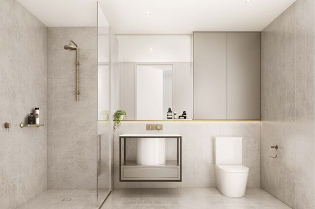 Contemporary minimalist bathroom with a walk-in glass shower on the left, wall-mounted vanity with a round vessel basin, mirrored cabinetry, and a wall-hung toilet. Large pale grey stone-look tiles cover the walls and floor, creating a clean, calm and refined interior.