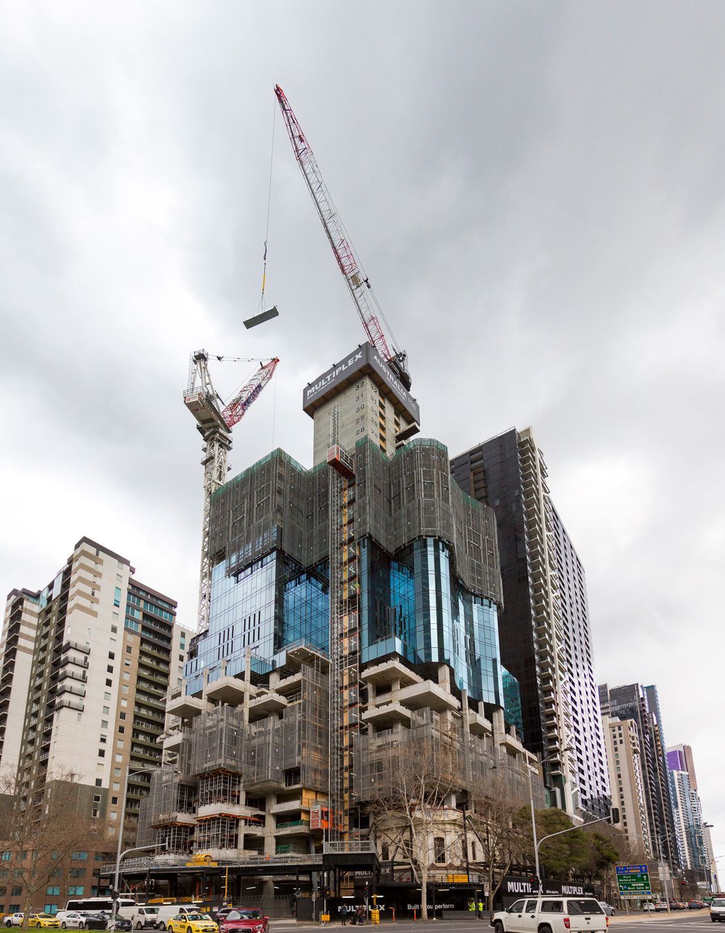 The progression of Australia 108 from its early construction (left) to completion (right).