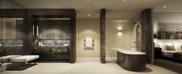 A luxurious contemporary ensuite bathroom with a freestanding oval bathtub, double vanity with dark marble surfaces, mirrored cabinetry, walk-in shower, and warm recessed lighting. A bedroom is visible directly through the opening on the right, clearly establishing the bathroom as an ensuite.