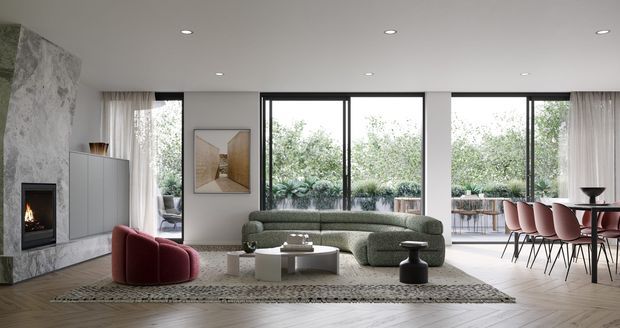 A bright, open-plan contemporary living and dining area with floor-to-ceiling black-framed glazing overlooking landscaped greenery. The room features a curved olive-green sectional sofa, burgundy lounge chair, low white coffee tables, a large textured rug, a marble-clad fireplace wall with built-in firebox, and a dining table with pink upholstered chairs. Pale timber flooring and recessed ceiling lights create a refined, modern interior.