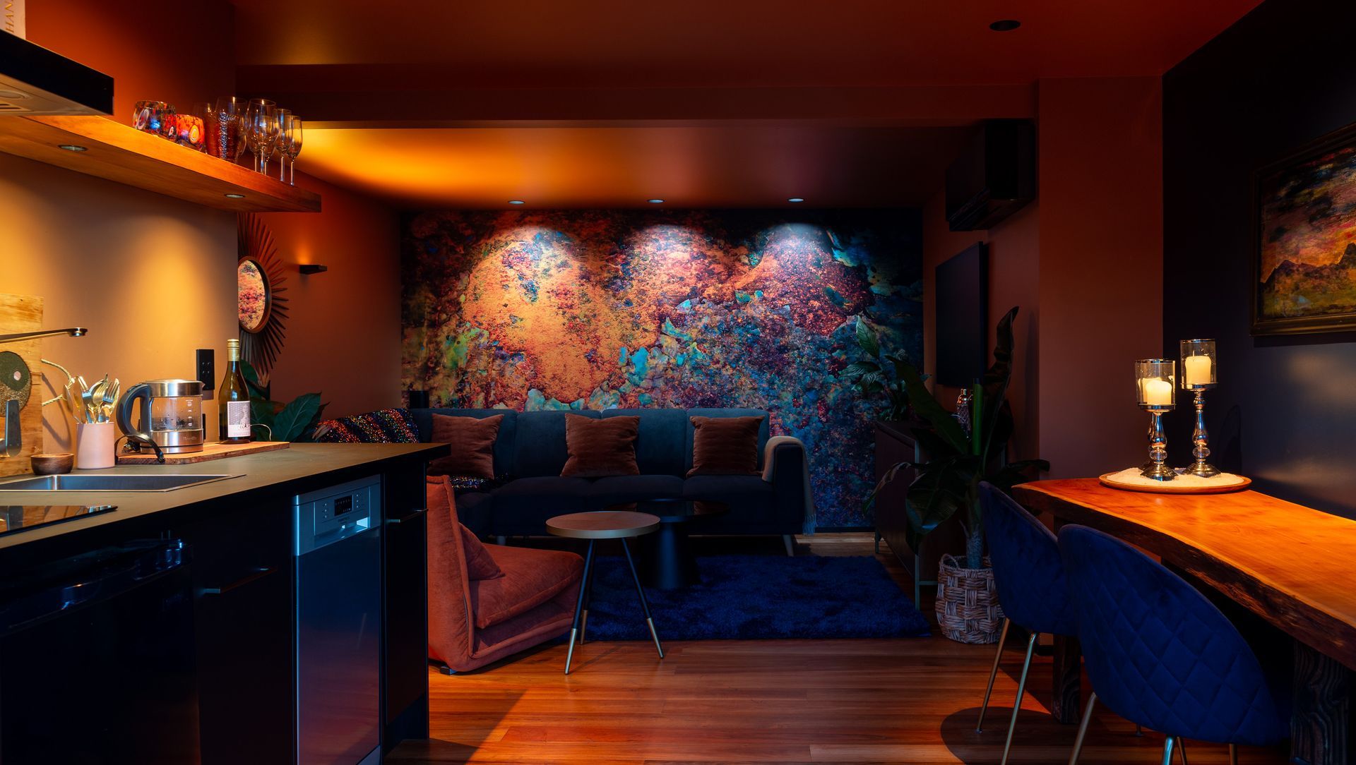Abstract mural wall, illuminated with a variety of colour temperatures to highlight different colour ranges in the artwork, ranging from 1800K on the left, to 3000K in the centre, and finally 4000k on the right. Product: Switch Lighting ZELA Offset Deep Tilt SLDL251T
