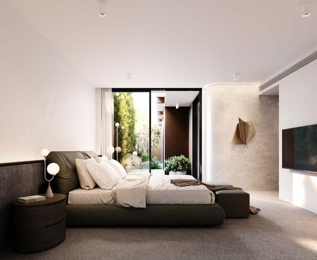 A refined contemporary bedroom with a low-profile upholstered bed, layered neutral bedding, dark rounded bedside table, sculptural bedside lamps, wall-mounted television, and textured light wall finishes. Full-height black-framed glazing opens toward a planted courtyard, bringing greenery and natural light into the room. The palette is predominantly soft white, taupe, grey, and dark charcoal, creating a calm, luxurious atmosphere.