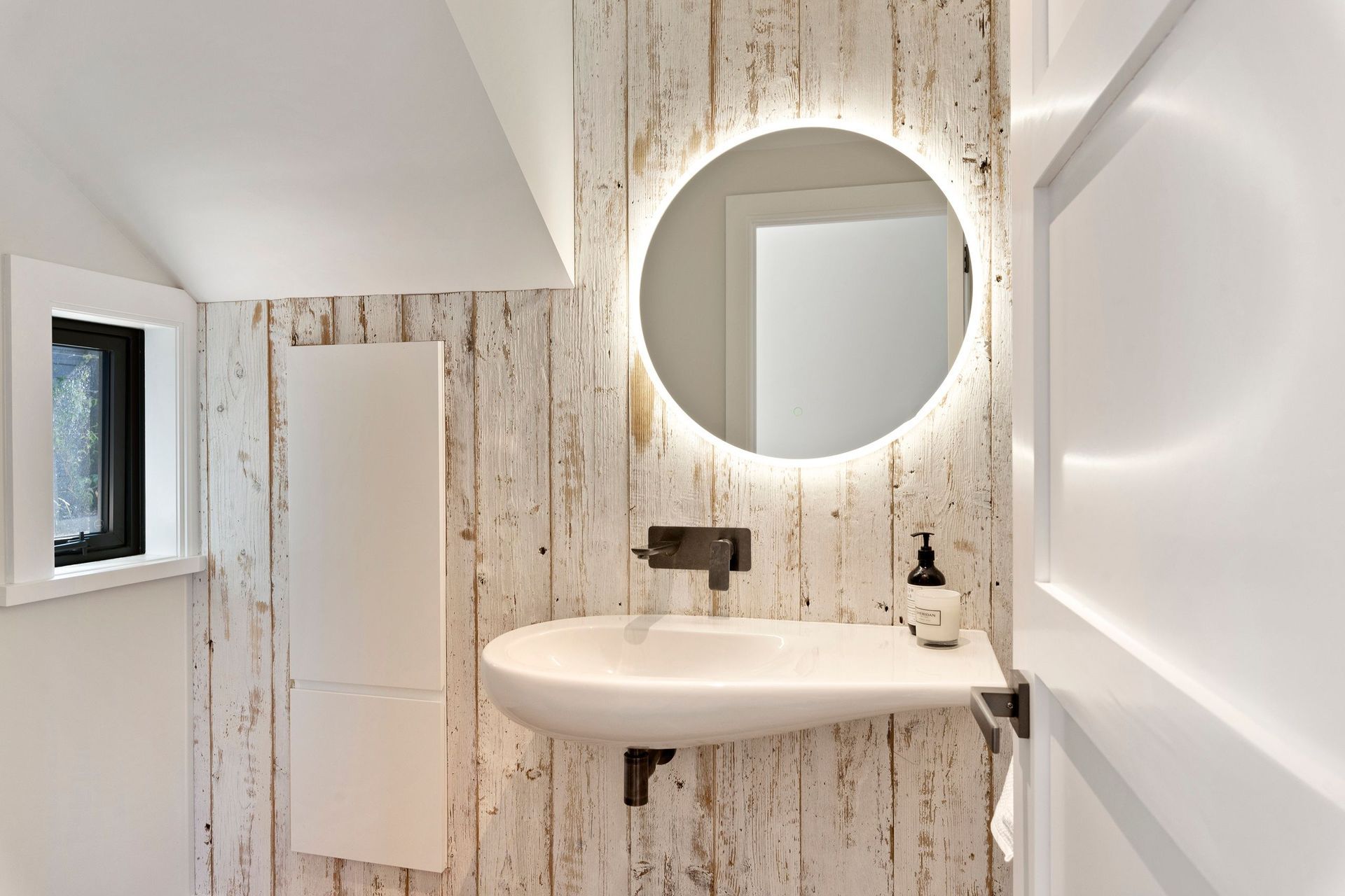 The powder room, too, has the pared back, neutral scheme.