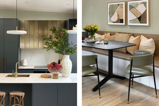 A split-view contemporary open-plan kitchen and dining area. The kitchen features dark charcoal cabinetry, a pale stone island benchtop, brass-toned fixtures, a light marble-look splashback, vertical timber wall panelling and pendant lighting. The adjacent dining space has a dark rectangular table, olive green upholstered chairs, a built-in upholstered banquette with cushions, light timber flooring and framed abstract artwork.