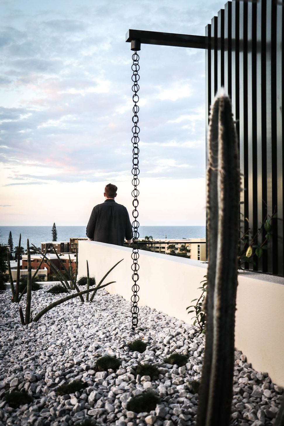 Anderson Residence - Balcony. Rain chain framing views to the ocean.
