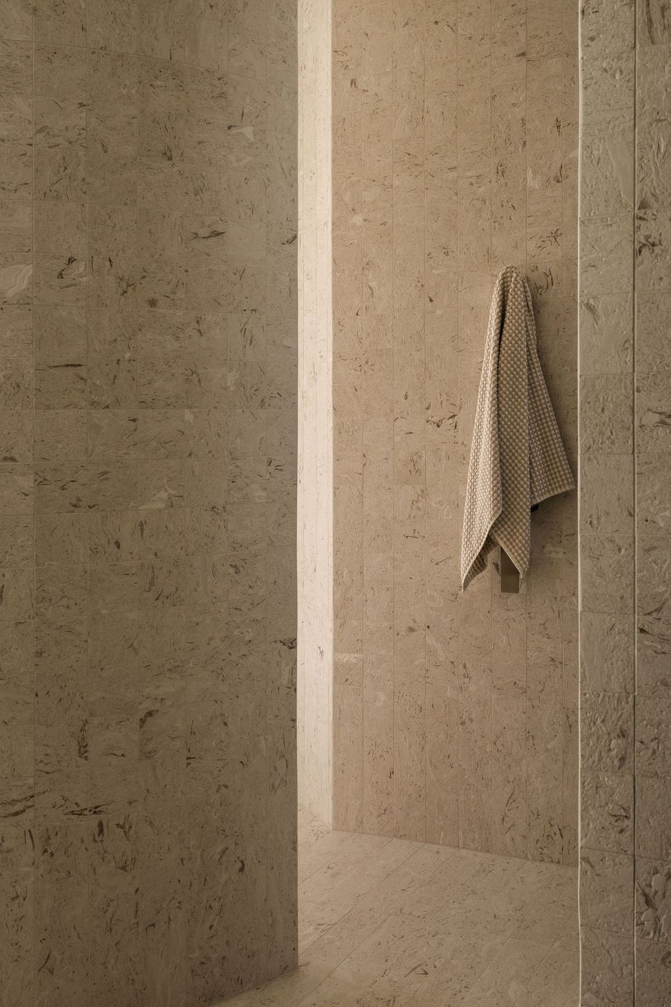 Solmere - Bathroom. Textured stone walls with a linen towel.