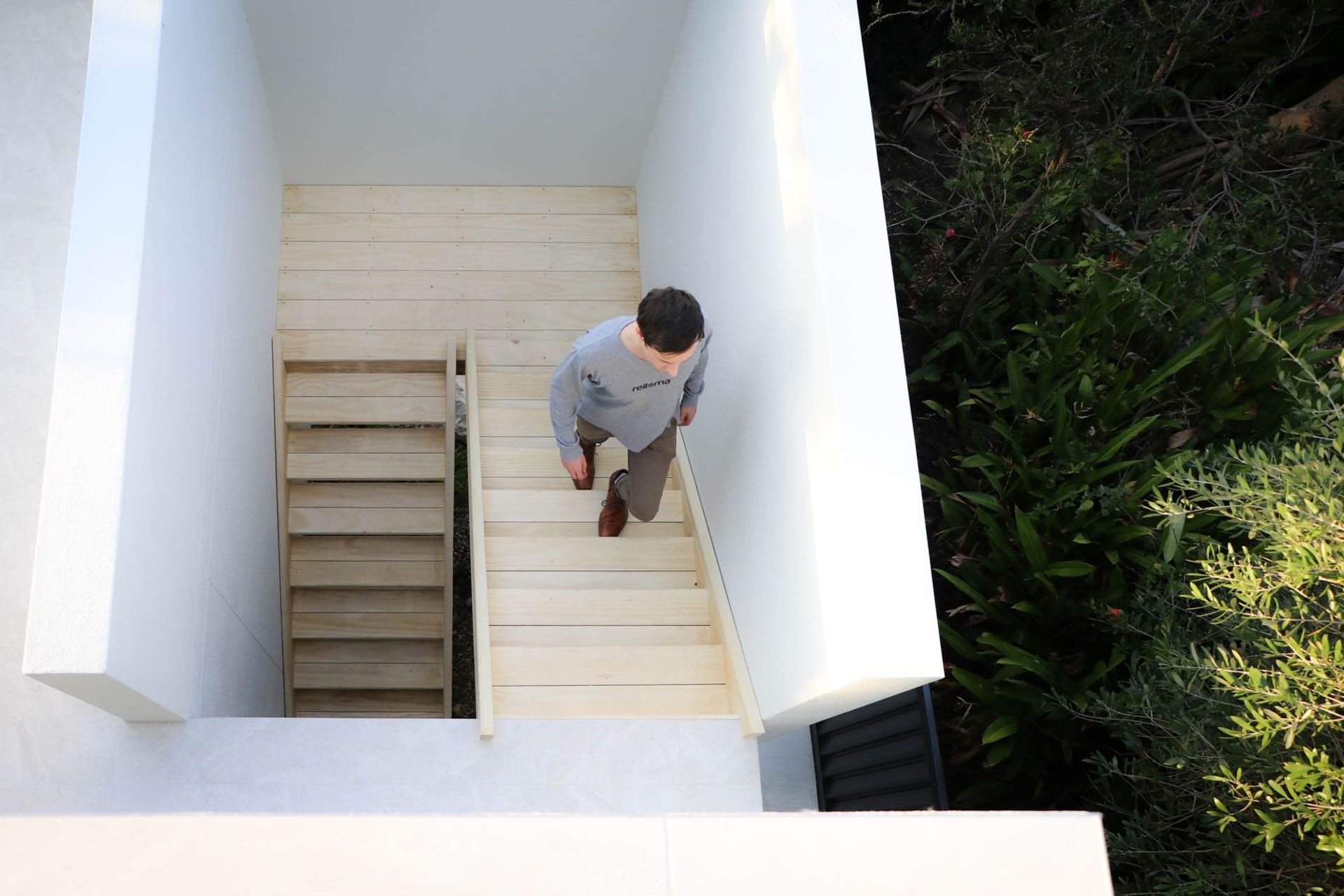 Anderson Residence - Staircase. Looking down the timber stair beside the garden.