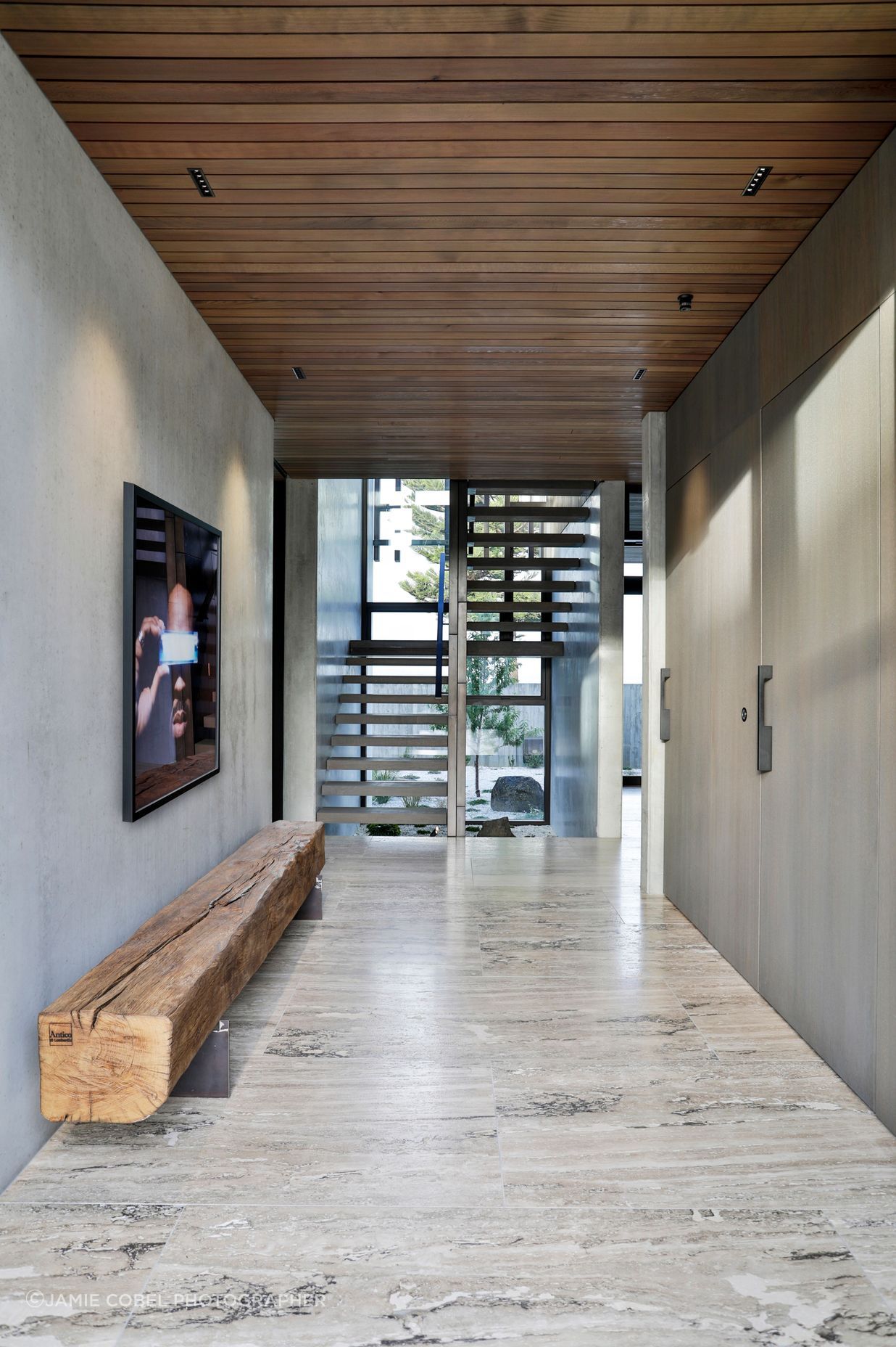 The stair well faces a second hallway that leads to the service and utility spaces.