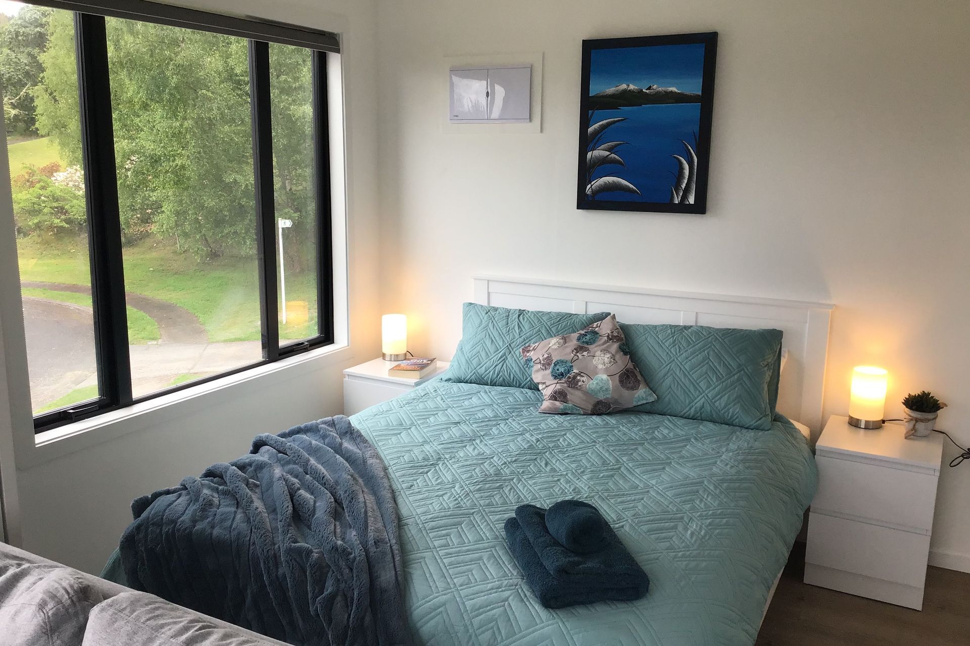 Bedroom features queen sized bed with space to access both sides