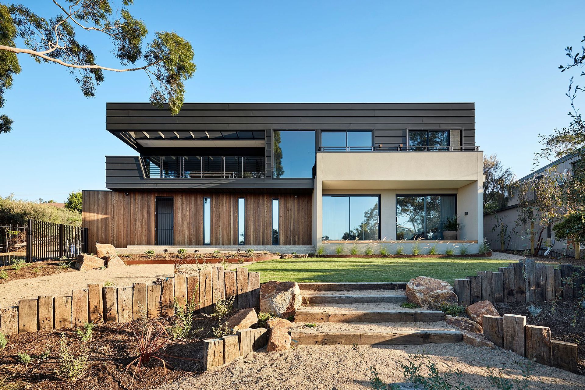 The house sits high on the block maximizing its northern outlook, and enveloped within a natural landscape that will grow organically and blur with the ti-tree surrounds.