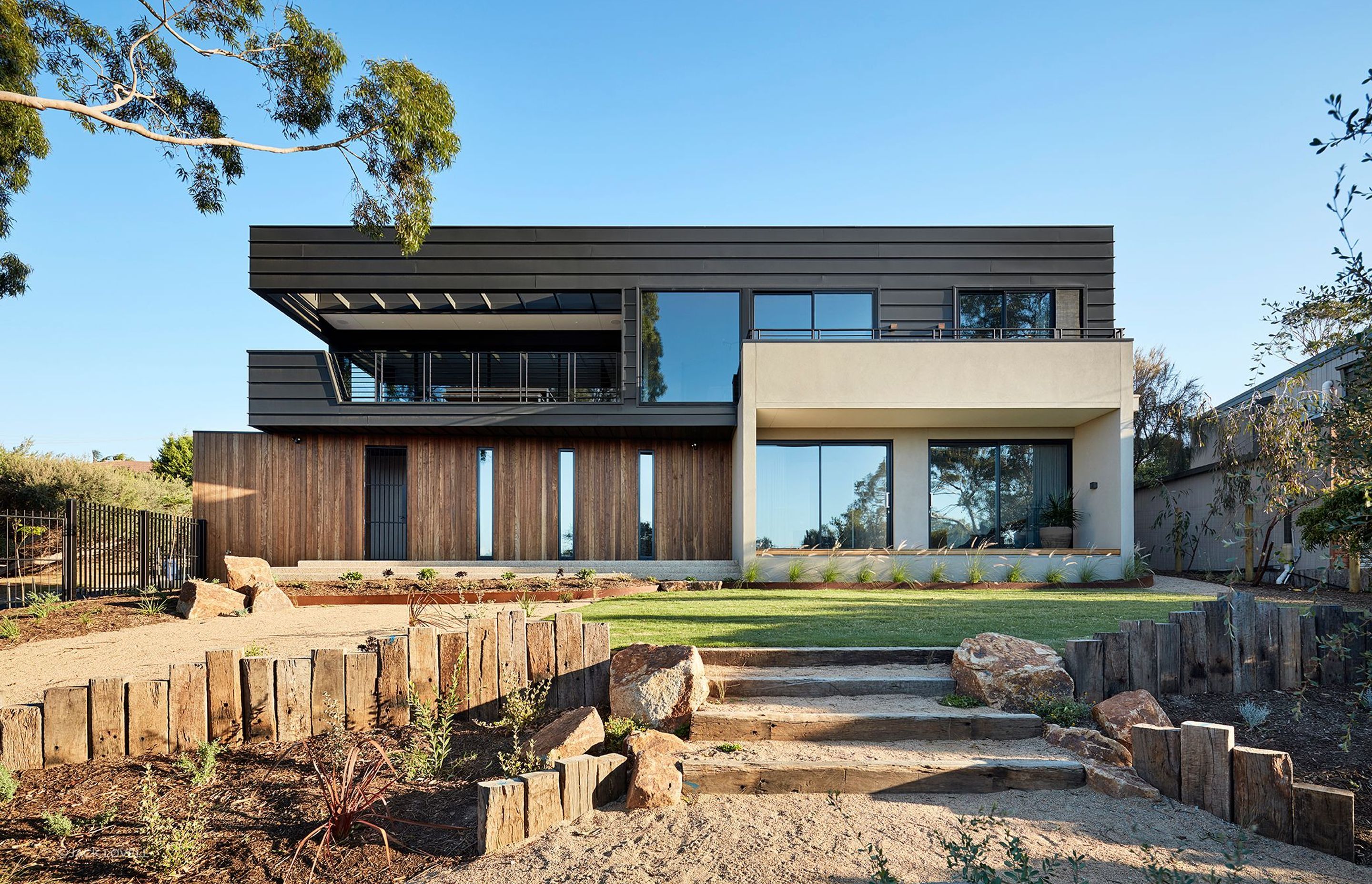 The house sits high on the block maximizing its northern outlook, and enveloped within a natural landscape that will grow organically and blur with the ti-tree surrounds.