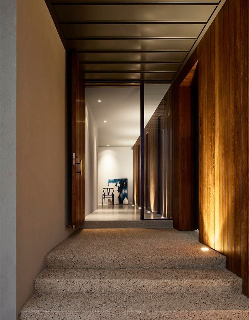 Up-lit timber walls lead guests into the darker, moodier, lower floor.