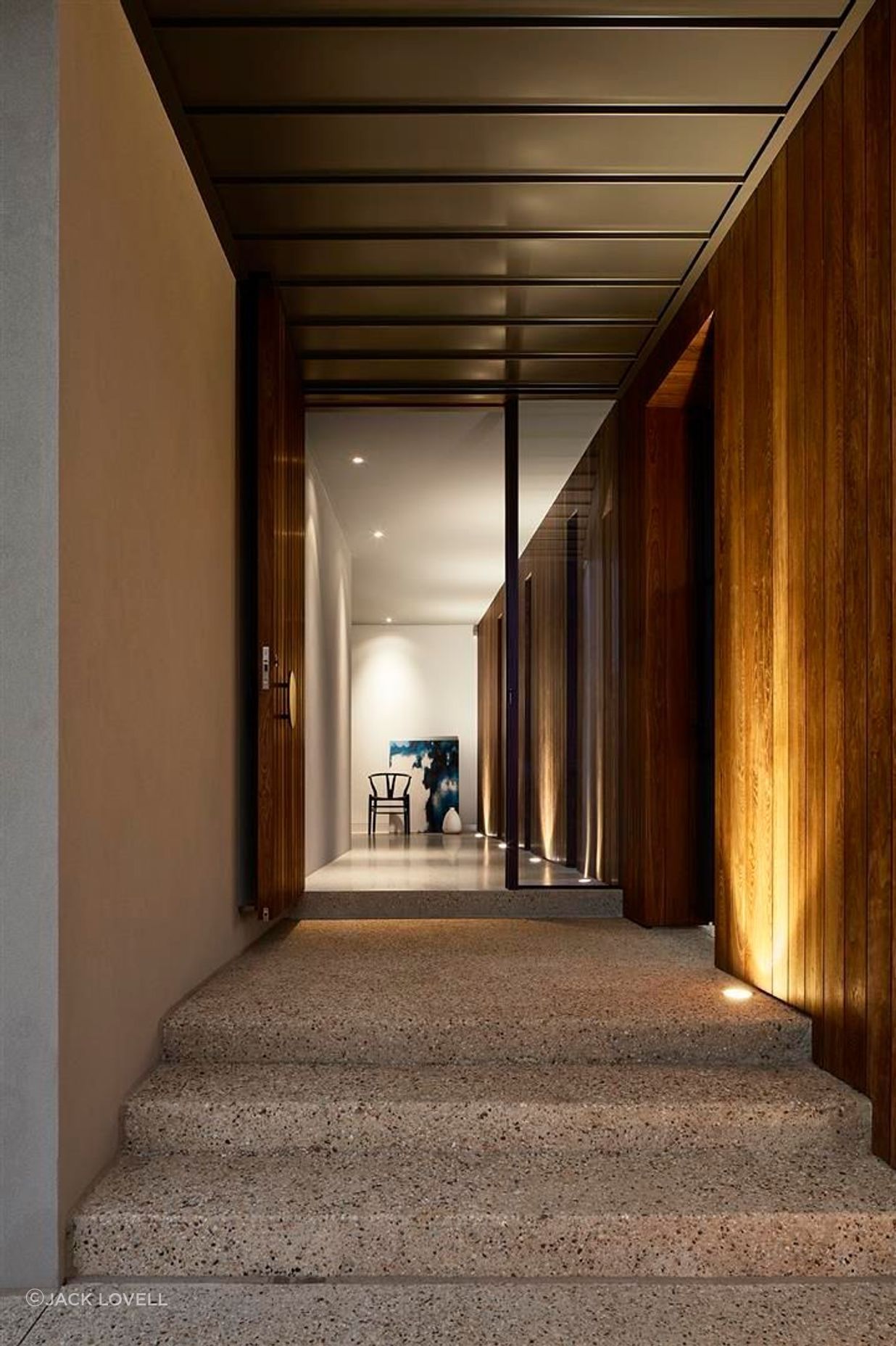 Up-lit timber walls lead guests into the darker, moodier, lower floor.