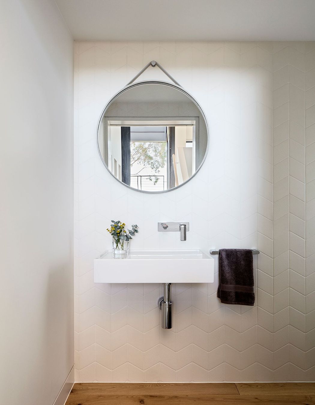 At the mid-point landing of the stairs is a small powder room.