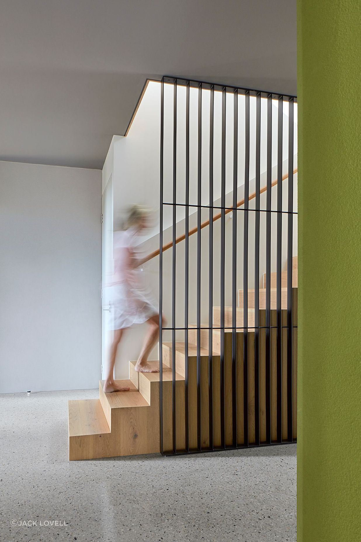 The interior scheme of the ground floor reflects the formal materiality – solid, grounded concrete terraces and rendered block balanced with polished-concrete screed floors and charcoal coloured ceilings. This broodiness is punctuated by the organic shape of the green rendered cellar – a shot of colour repeated throughout the house.