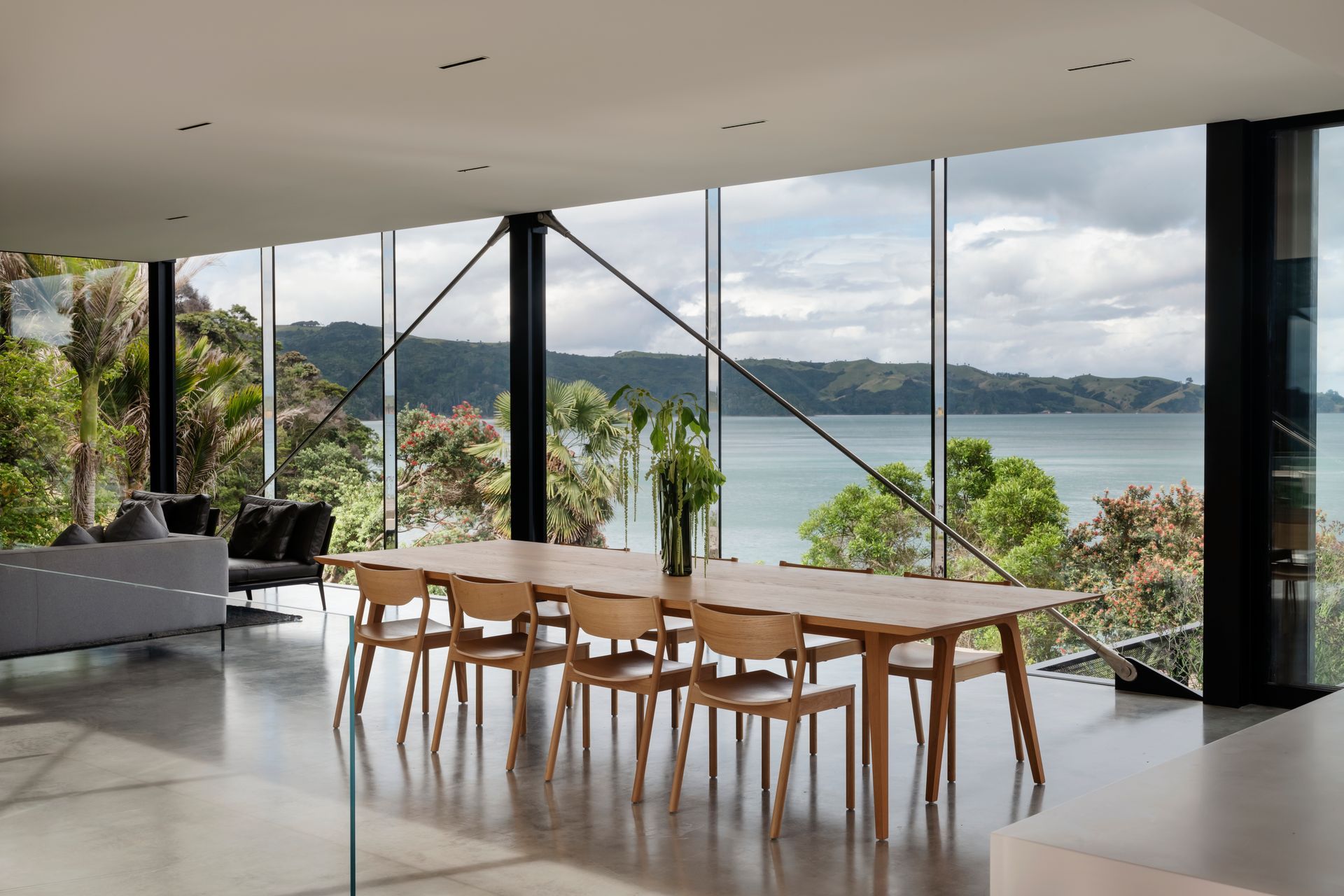 Sunset striking through low reflective glass hitting and reflecting onto the delicate timber furnishings.