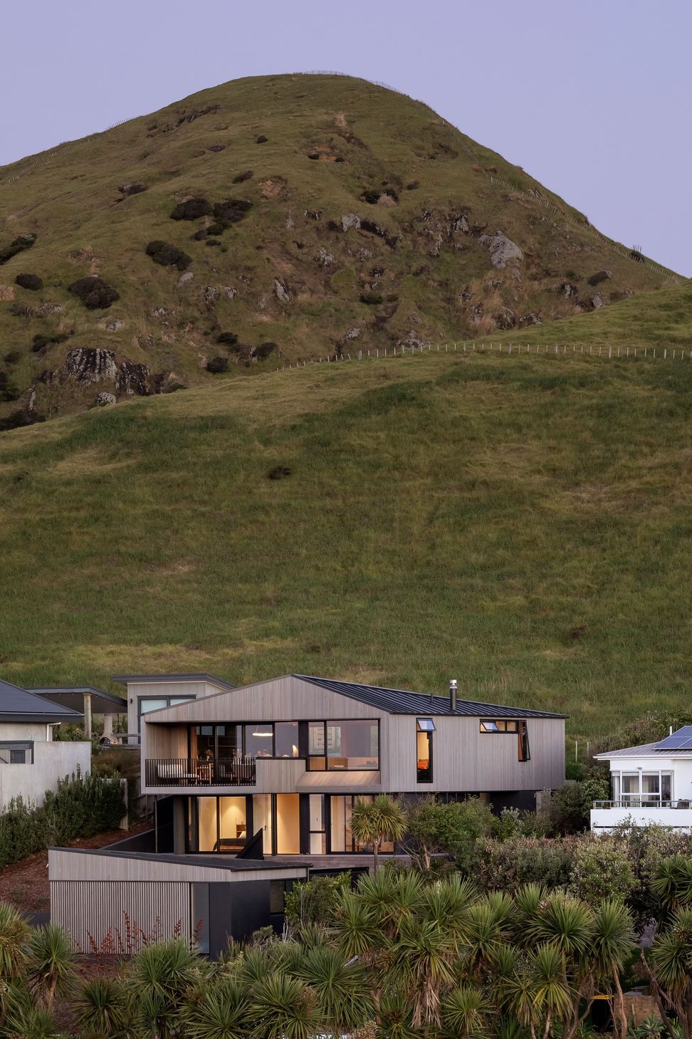 The hill appears to preside of the home.