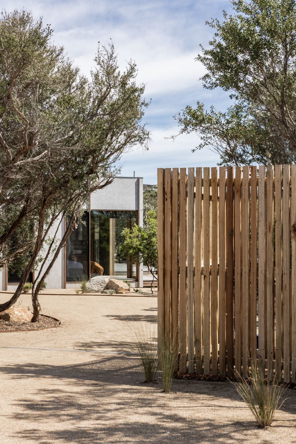 Coastal Tea Tree and a rough-sawn Australian hardwood batten fence provide total beach house seclusion