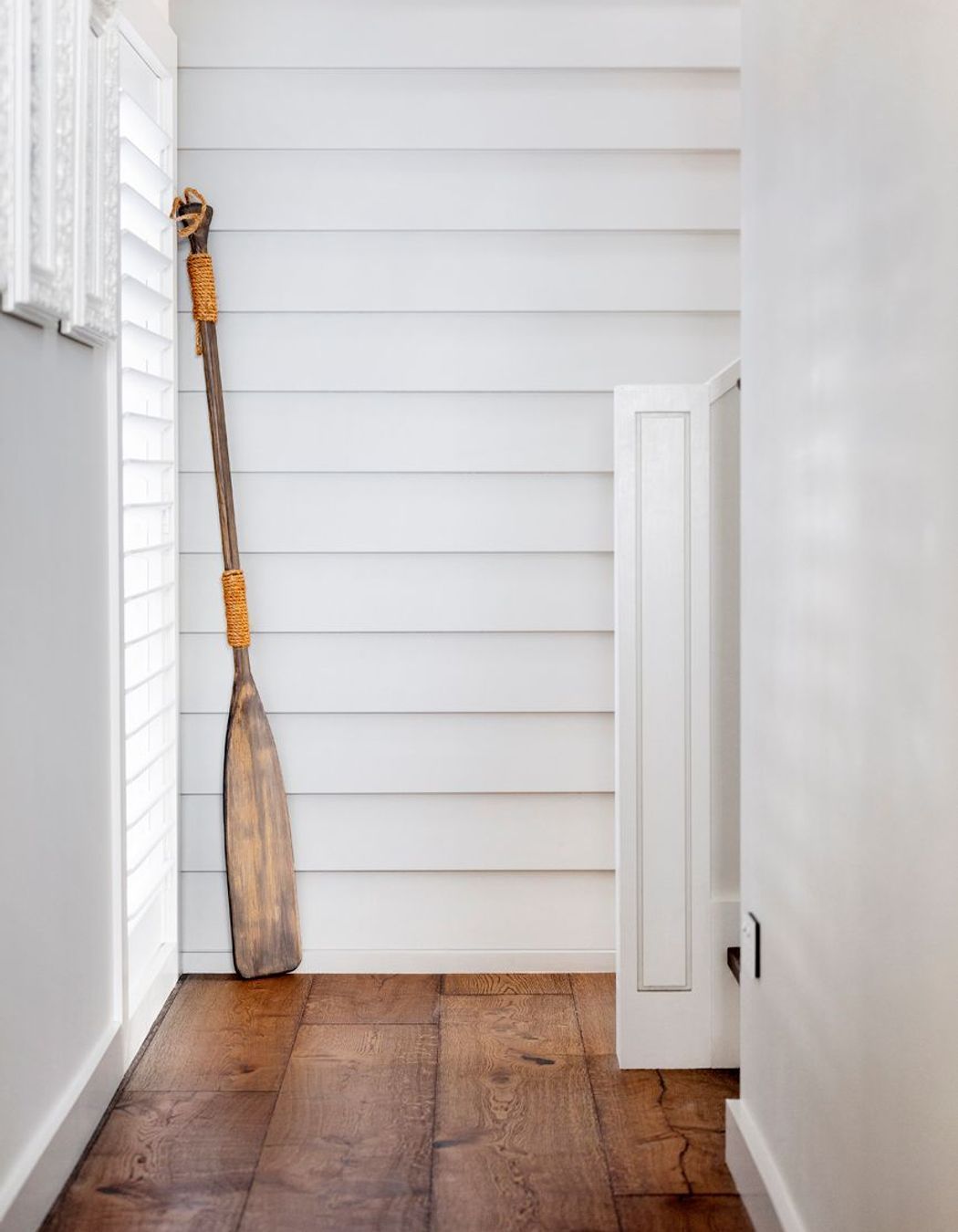 Programmatically, the house is two connected pavilions, accessed by weatherboard-clad staircases.