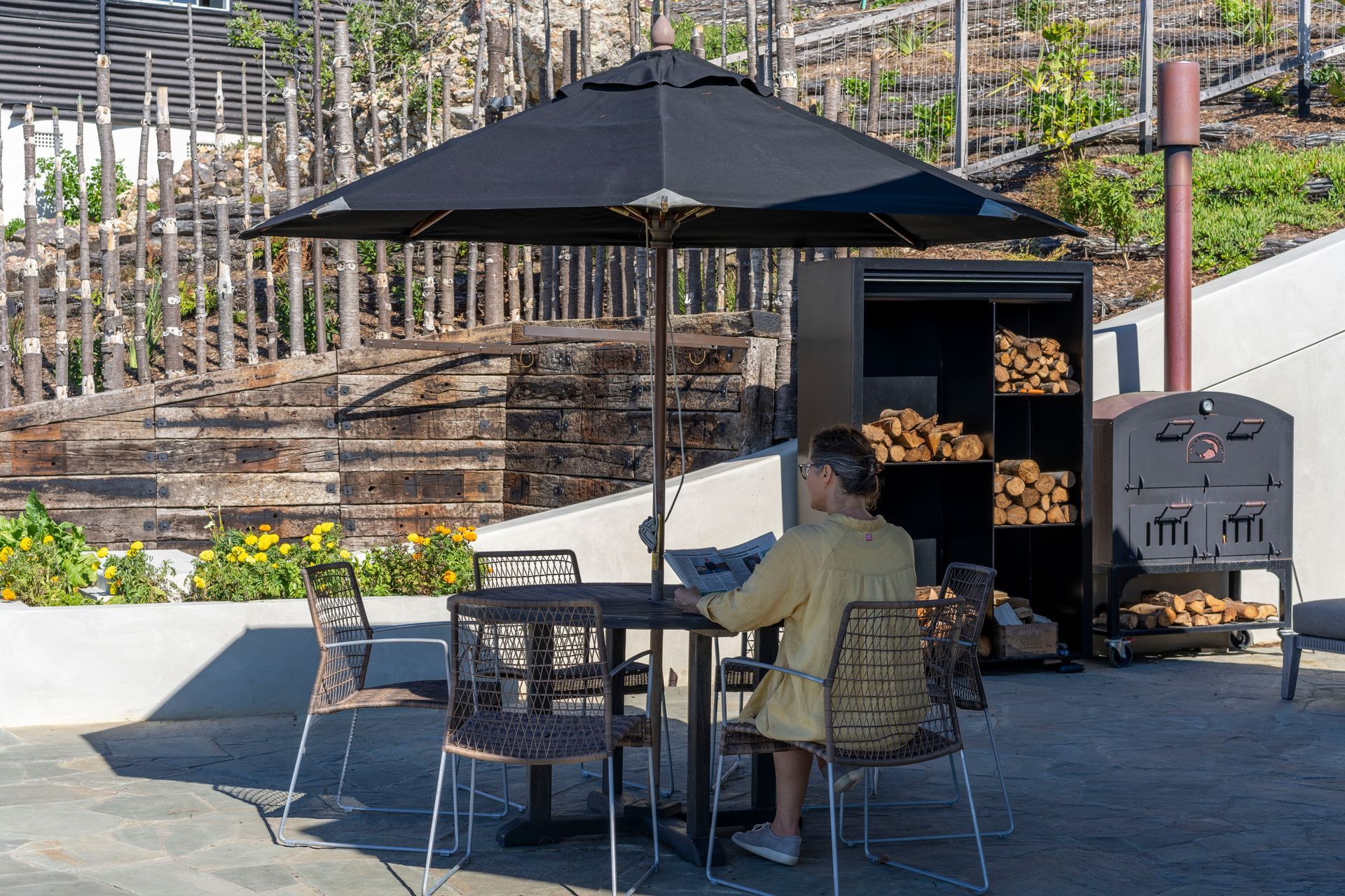 The concrete retaining wall creates a sheltered, multifunctional outdoor space.