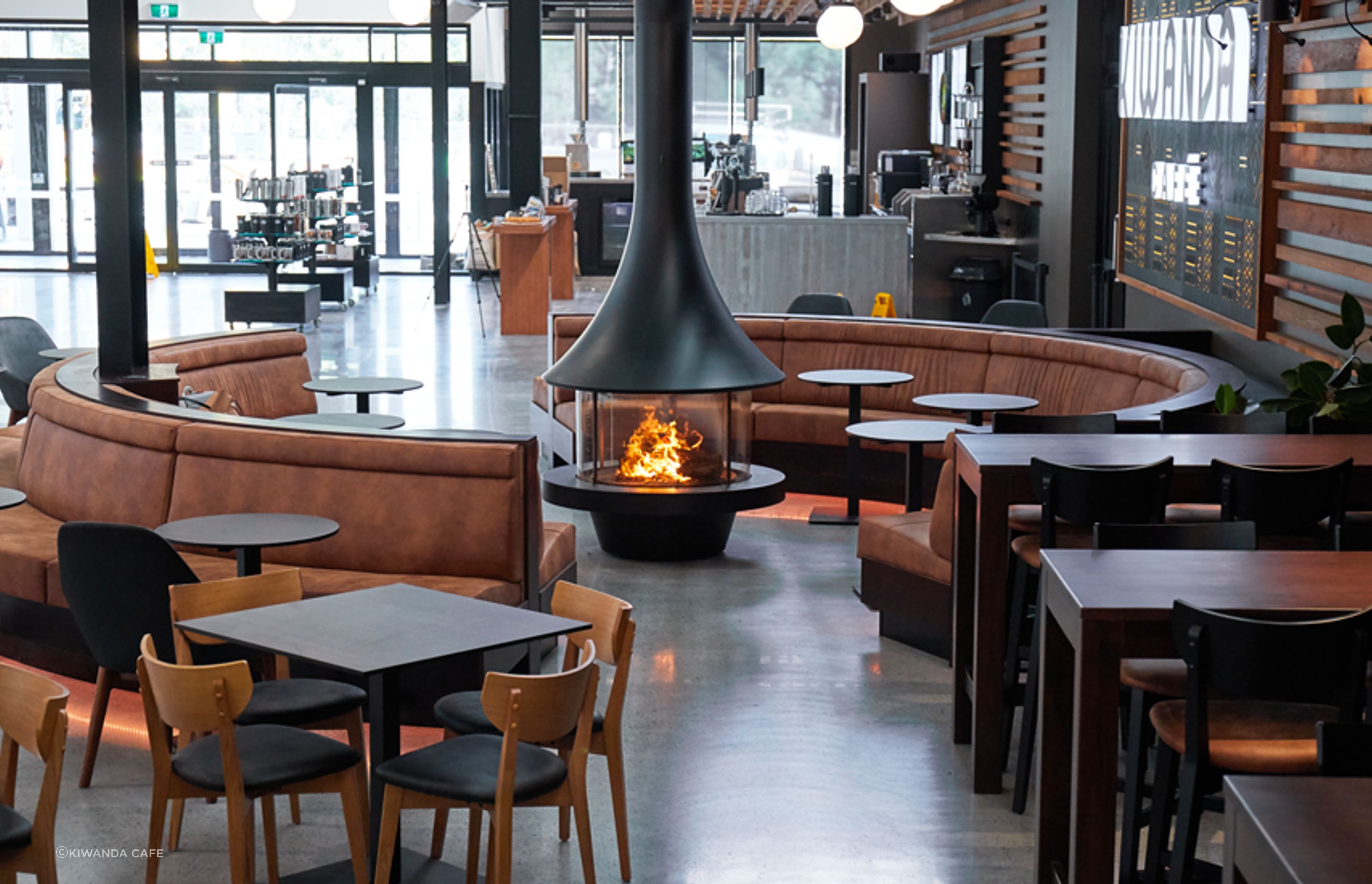 The JC Bordelet Eva 992 wood fireplace, providing a place for customers to enjoy an artisan coffee in a relaxed ambient environment