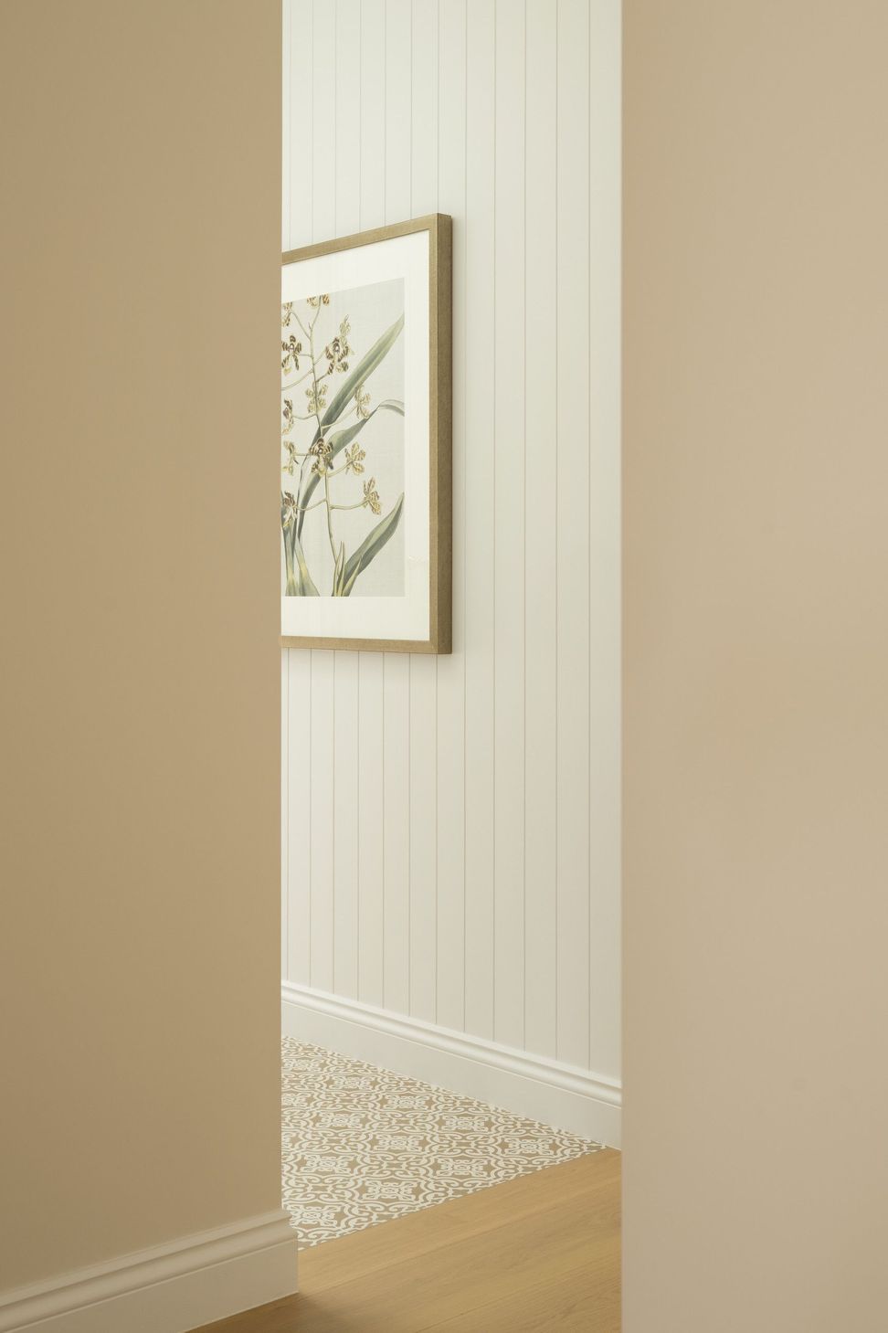 Euroa Farm - Hall. Vertical boarded walls and framed botanical artwork.