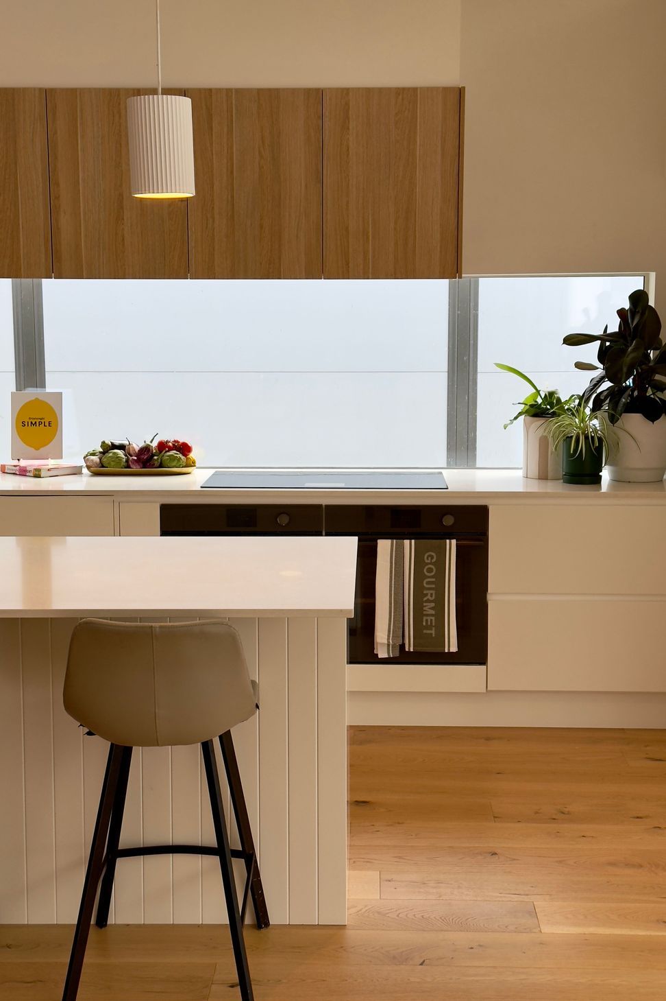 The quality of the light in the kitchen is enhanced by the splashback window