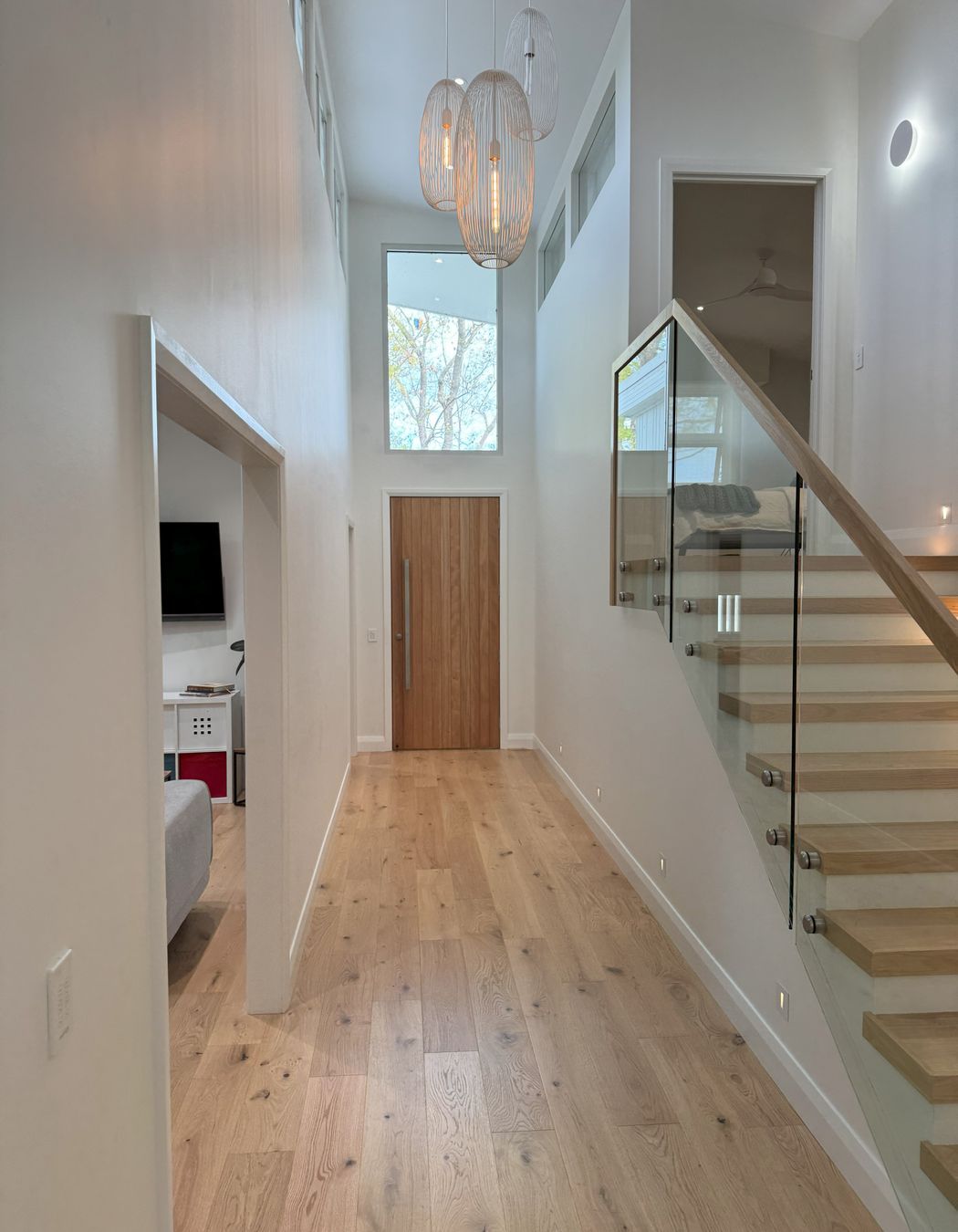 Double height entry flooded with natural light, spilling into the parents bedroom upstairs and into the kids rumpus room.