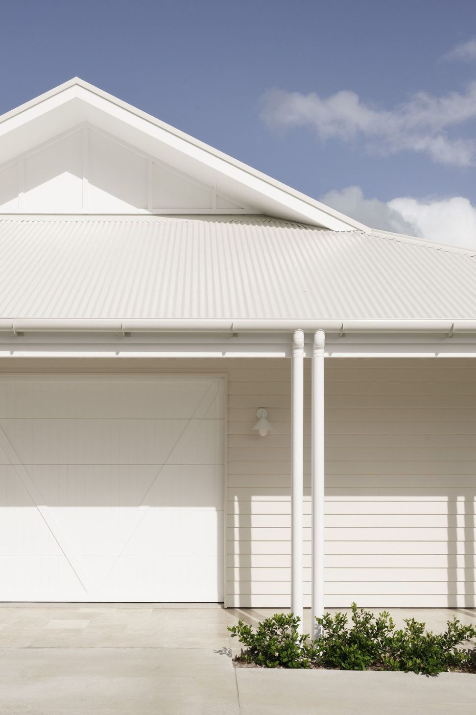 Euroa Farm - Exterior. Crisp white roof edge and verandah posts.