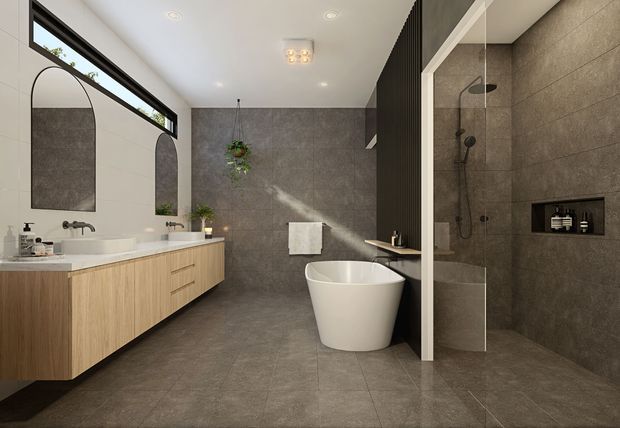 Contemporary bathroom with a floating light-wood vanity, white basin, black tapware, arched wall mirror, freestanding white bathtub, and a large frameless glass walk-in shower. Dark grey stone-look tiles cover the floor and walls, with recessed shower storage and black-framed clerestory glazing.