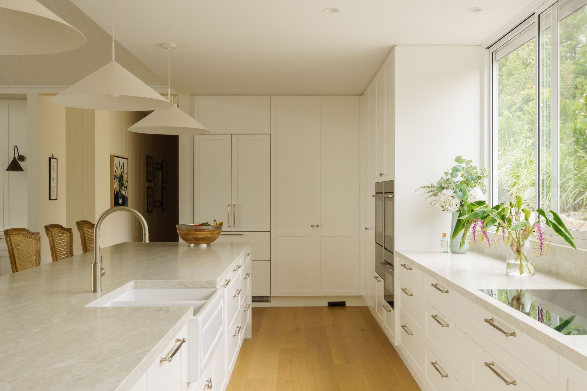 Euroa Farm - Kitchen. White kitchen with timber floors and a long island.