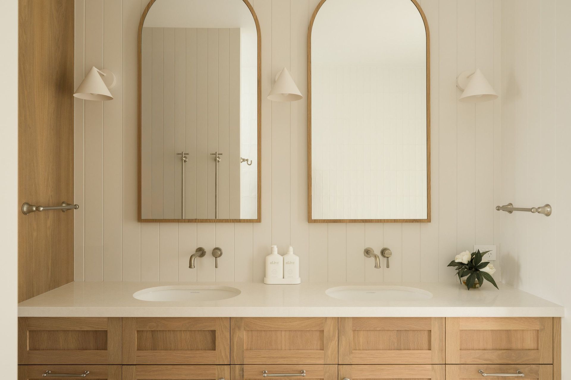 Euroa Farm - Bathroom. Double vanity with arched mirrors and wall sconces.