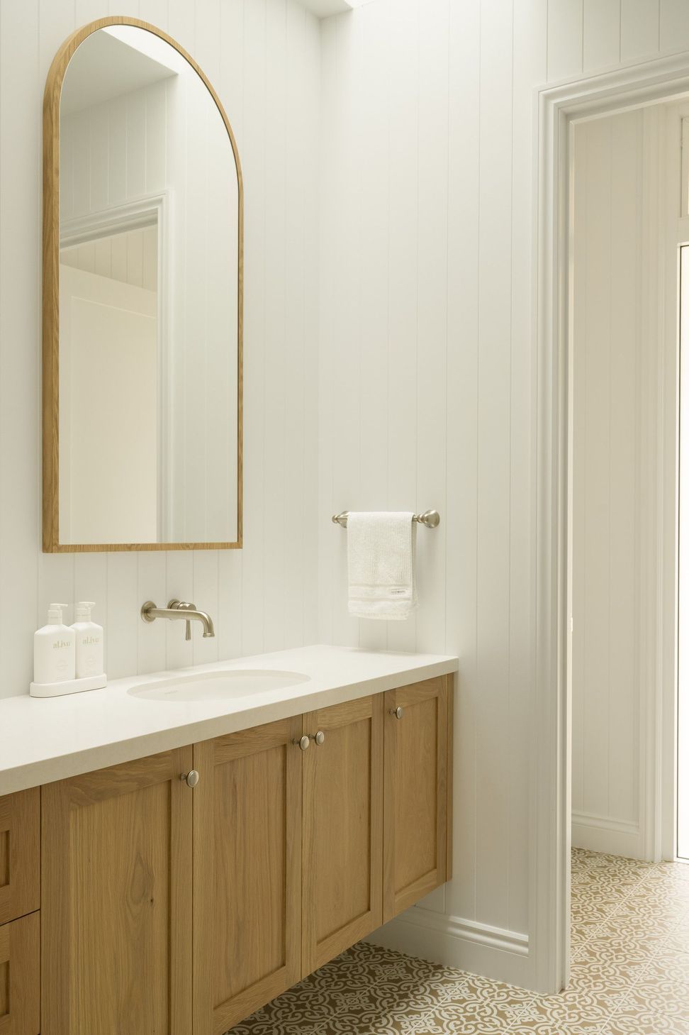 Euroa Farm - Bathroom. Single vanity with a timber framed mirror and towel rail.