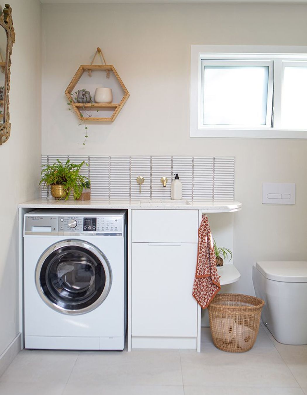 Design of the laundry was incorporated into the bathroom vanity unit.
