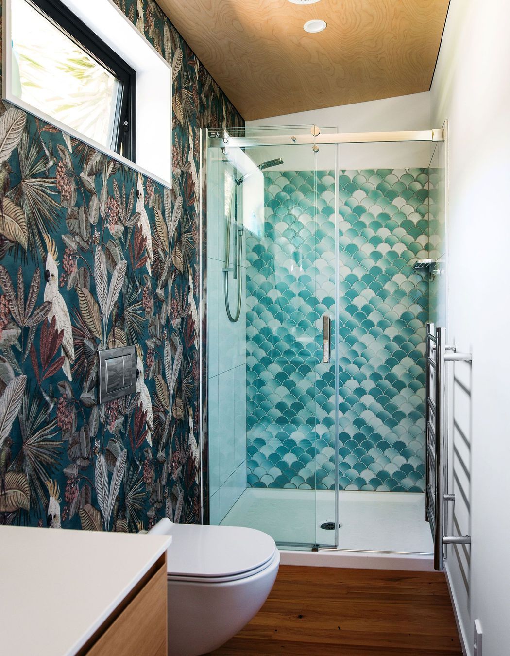 Tiled shower unit fits at the end of the space.