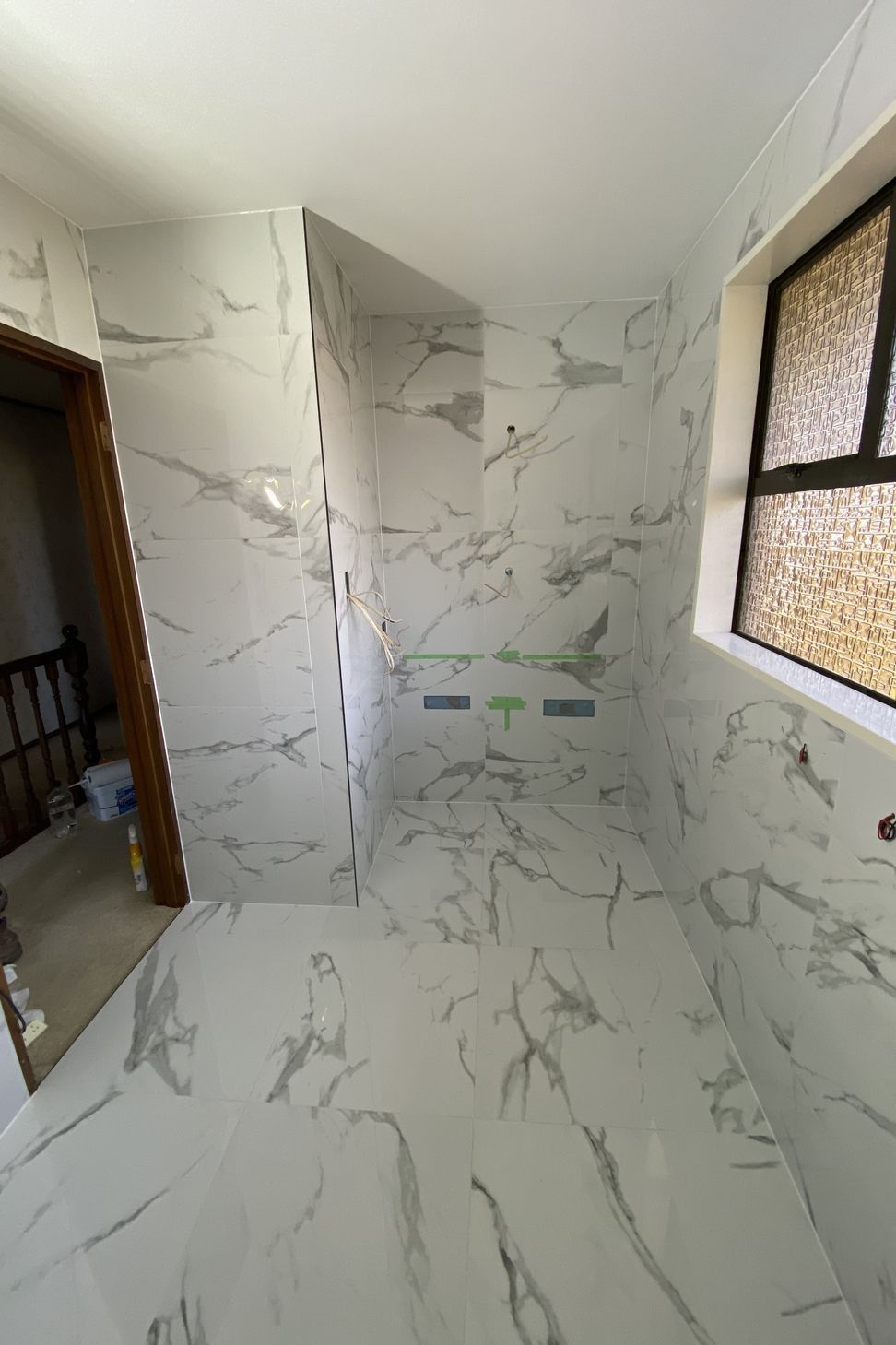 Tiled bathroom floor &amp; walls.